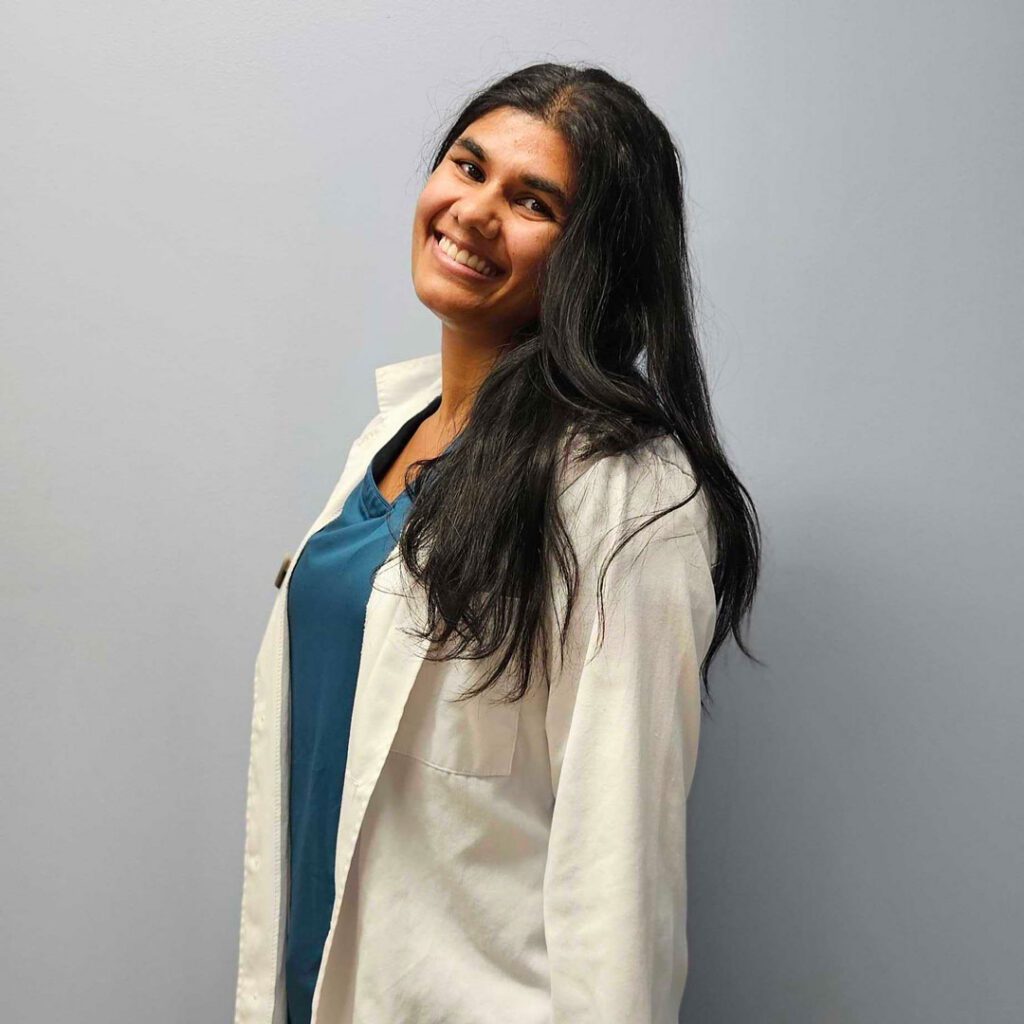 smiling female veterinarian with long black hair