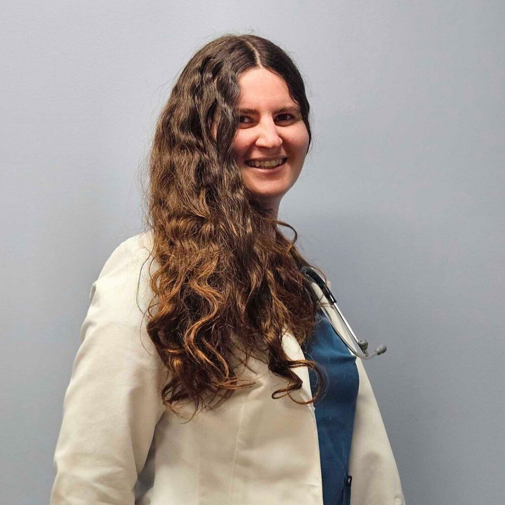 smiling female veterinarian with wavy brown hair