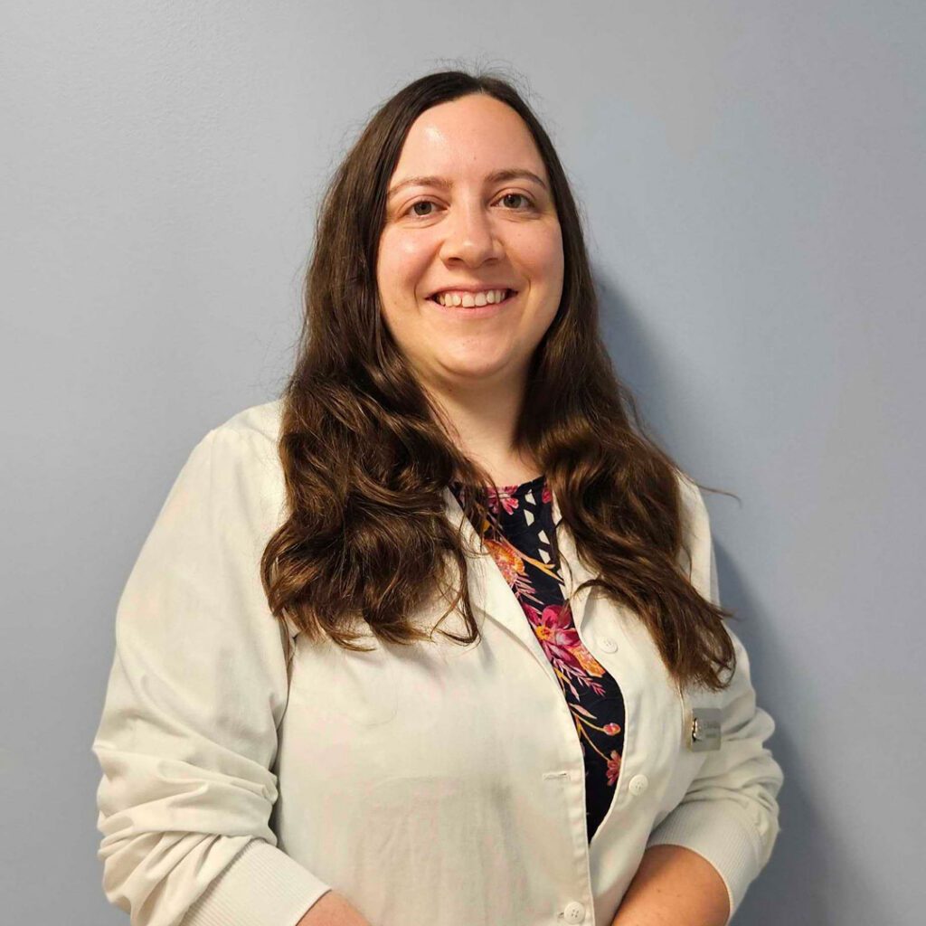 smiling female veterinarian with long brown hair